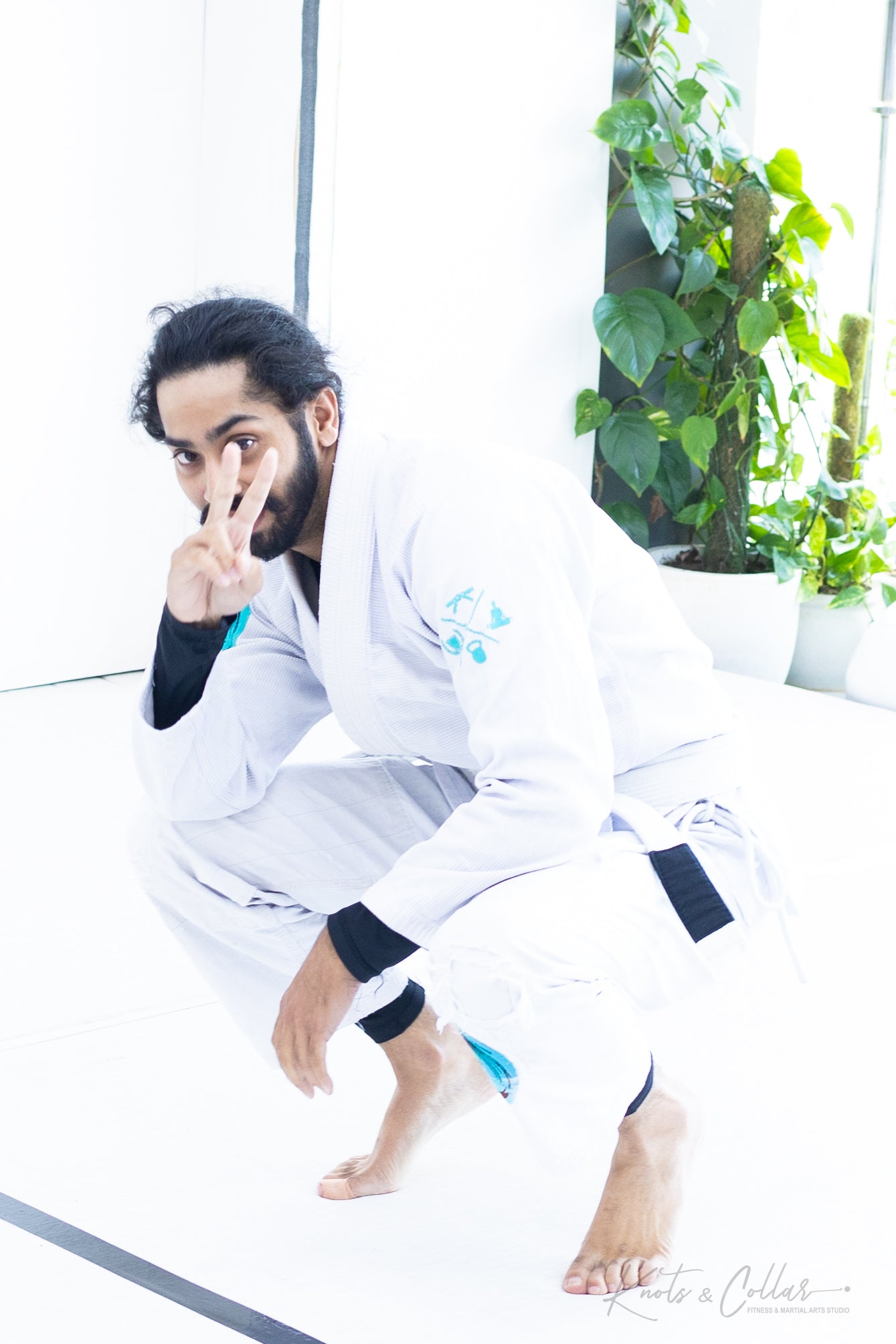 Students in gi uniform training BJJ at Knots and Collar Defence Colony