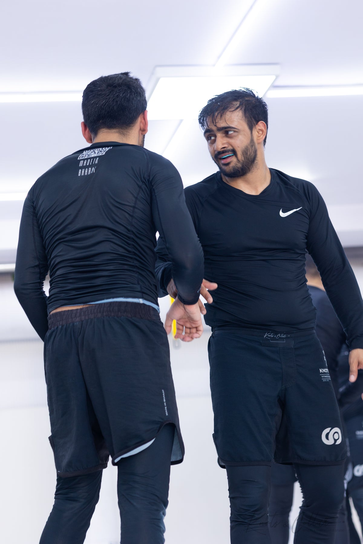 BJJ instructor mentoring a student, reflecting the Kindness Over Toughness teaching philosophy