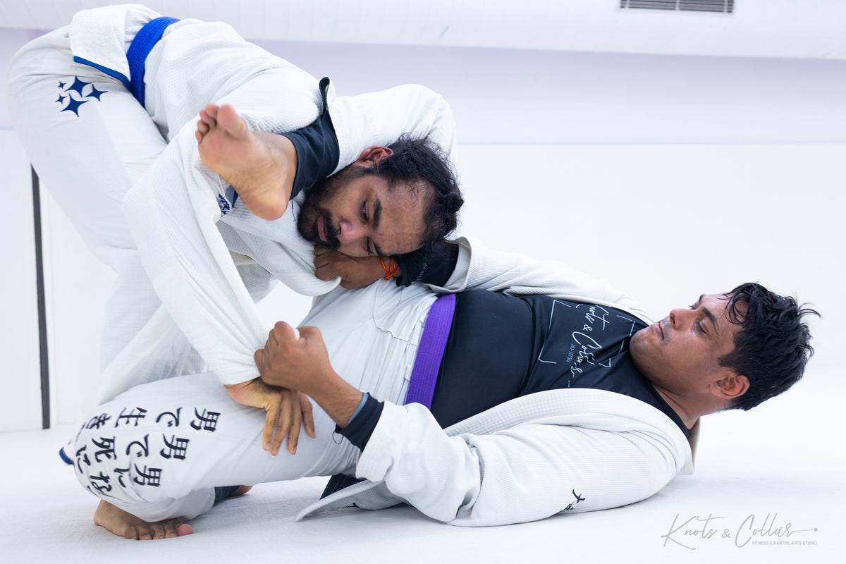 BJJ practitioners training a submission technique during a live grappling session
