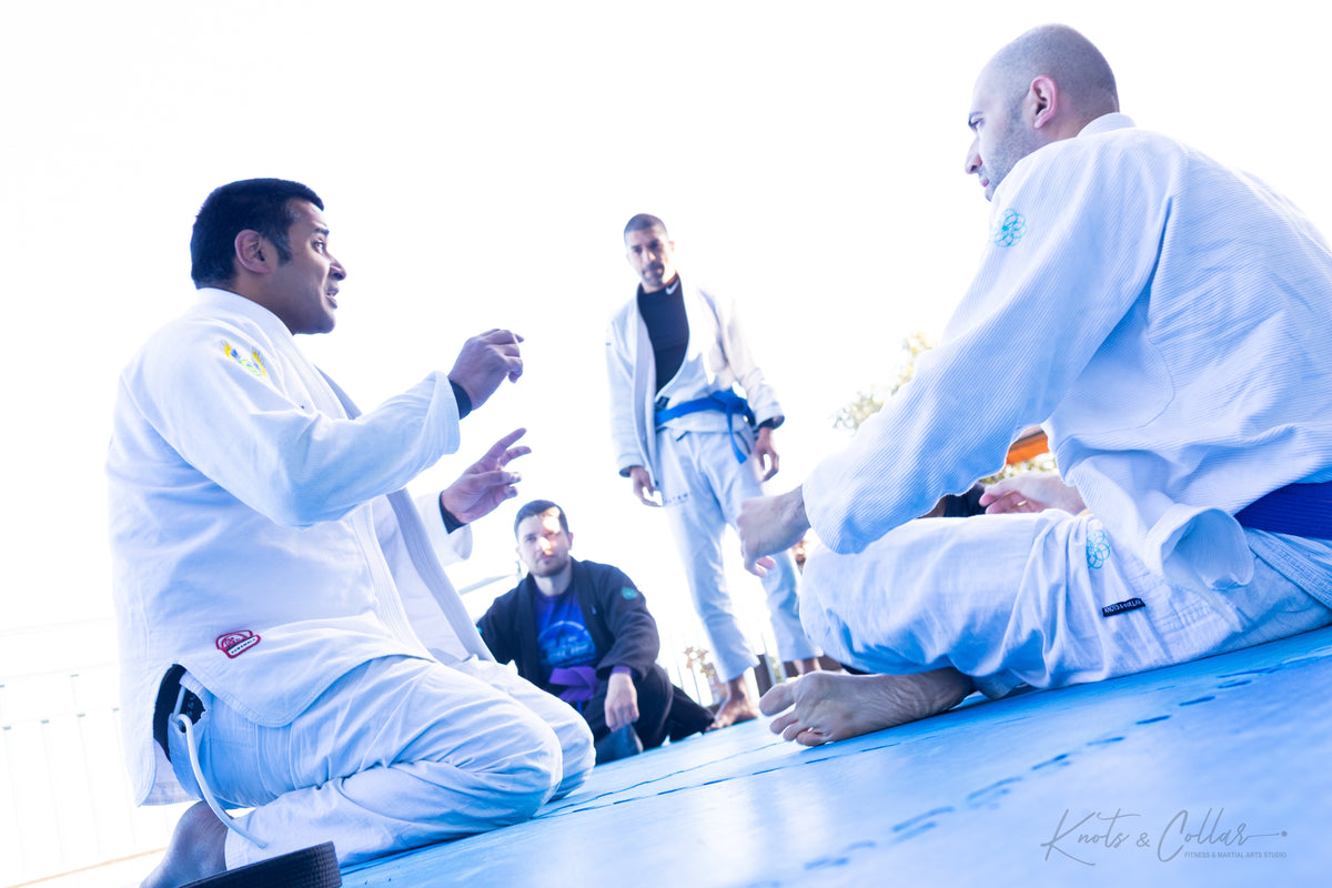 BJJ practitioners discussing technique during a training session at KC Manthan