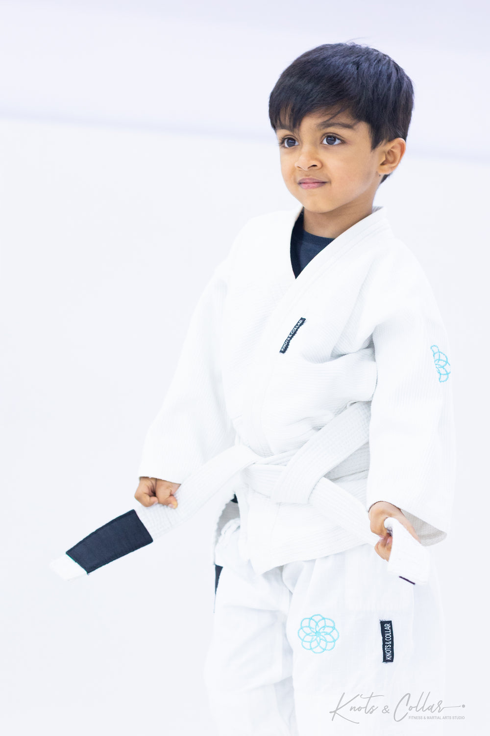 Confident young boy in BJJ gi at Knots and Collar kids jiu-jitsu class Defence Colony Delhi