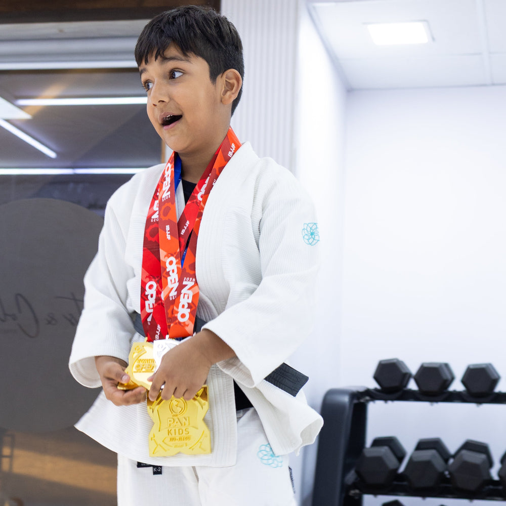 Young boy winning gold medal at kids BJJ competition Knots and Collar Defence Colony Delhi