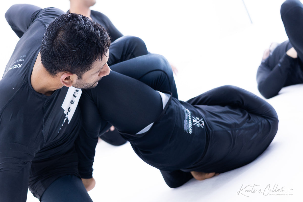 No-gi BJJ grappling exchange demonstrating full-body conditioning