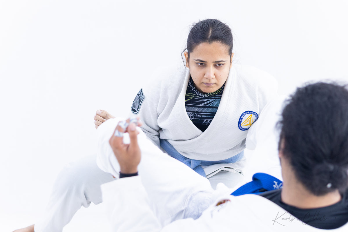 Woman learning BJJ technique in gi class at Knots and Collar Defence Colony New Delhi