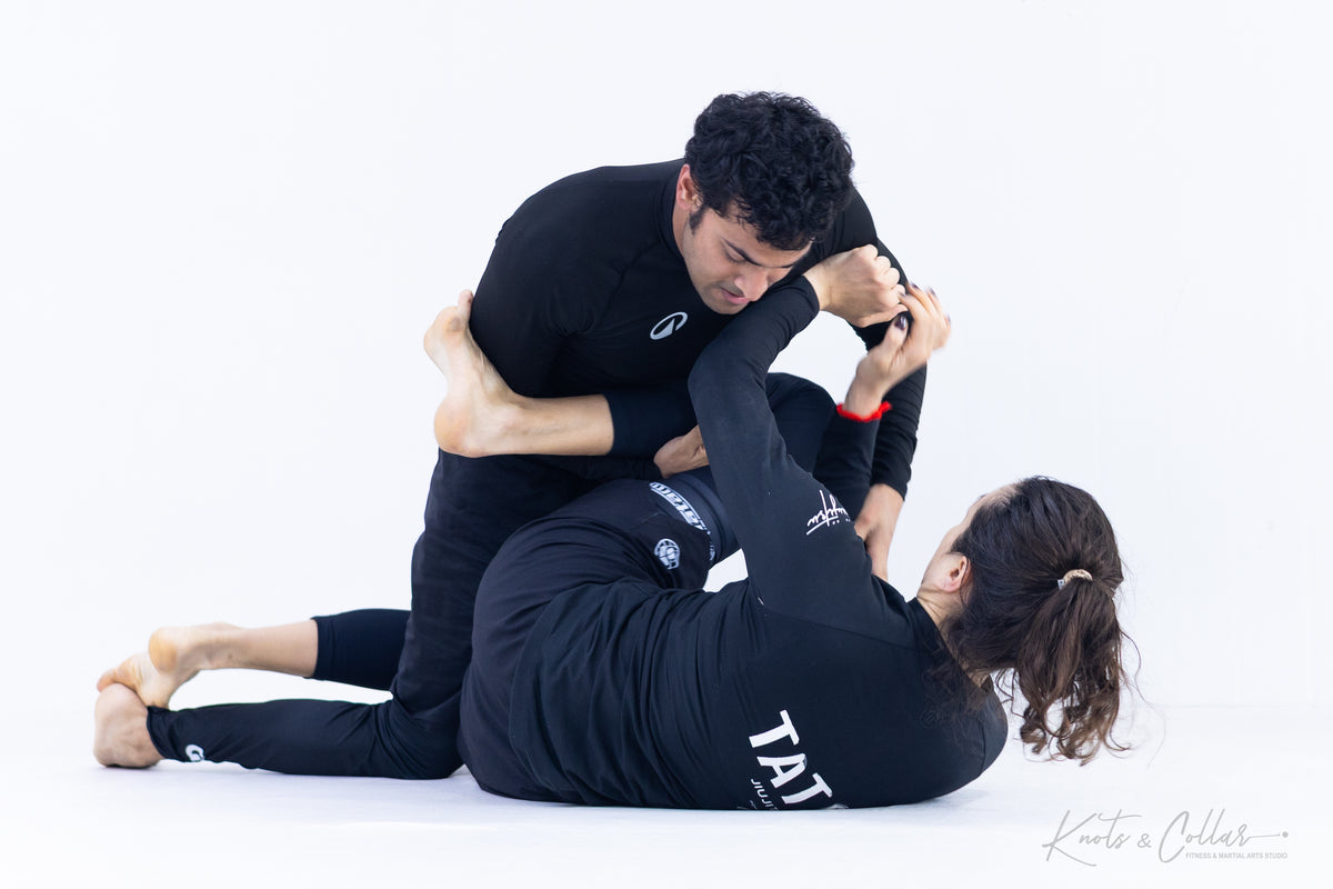 Woman training No-Gi BJJ with male partner at Knots and Collar Defence Colony Delhi